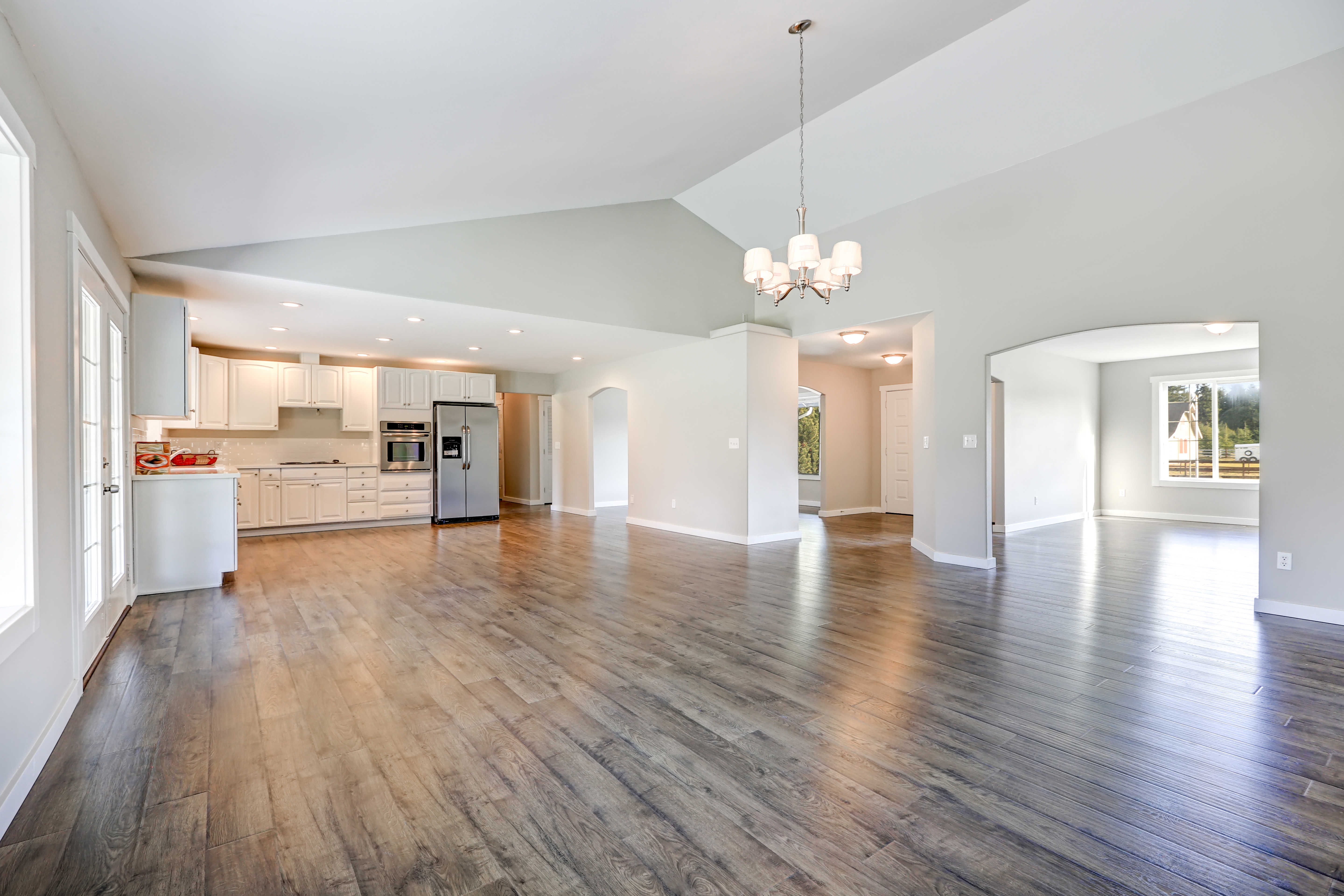 Bright open-concept home interior with newly installed wood-look flooring